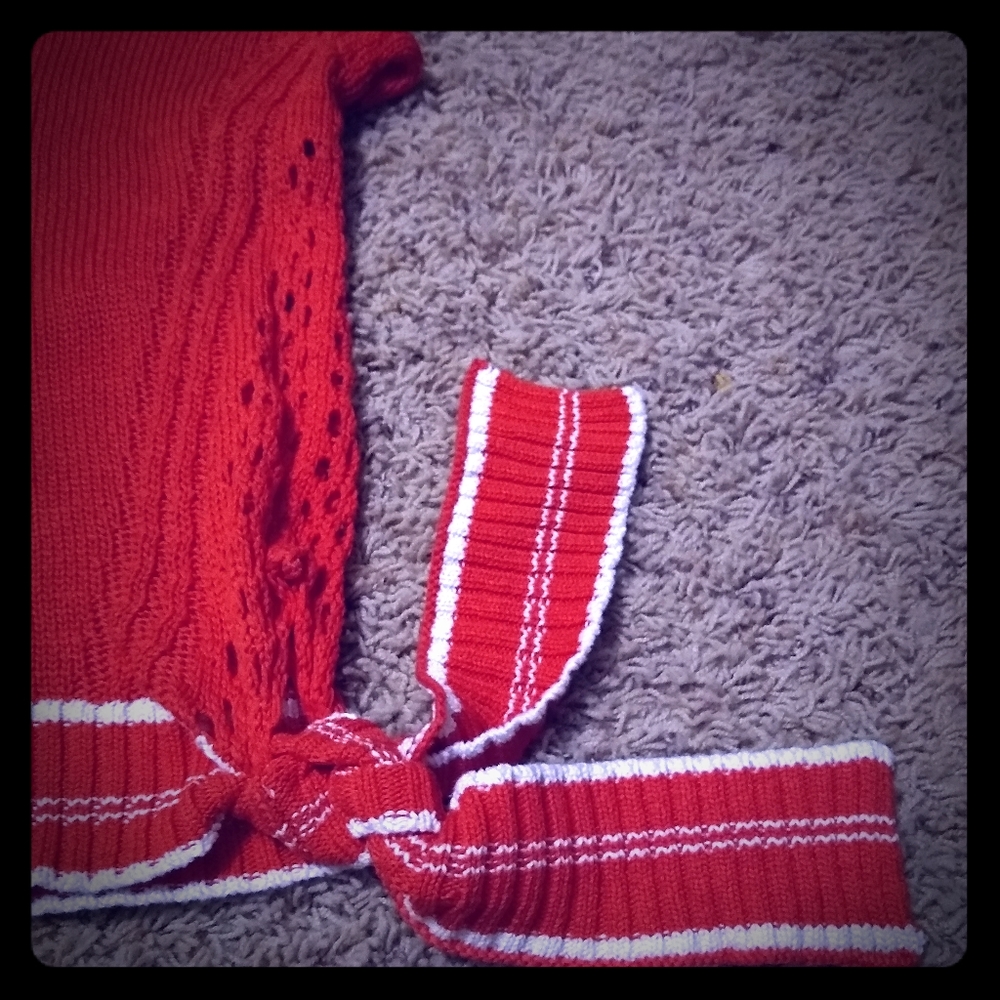 Knit sweater with side bow and cut-out detailing